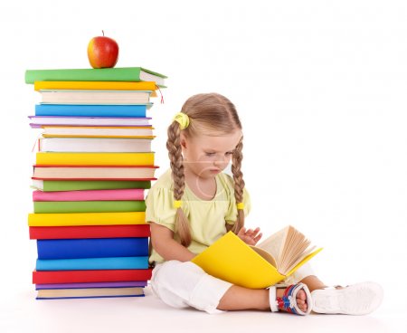 Child sitting on pile of books.