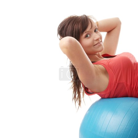 Young happy woman doing fitness exercise
