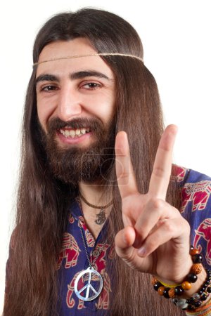 Friendly hippie with long hair making peace sign