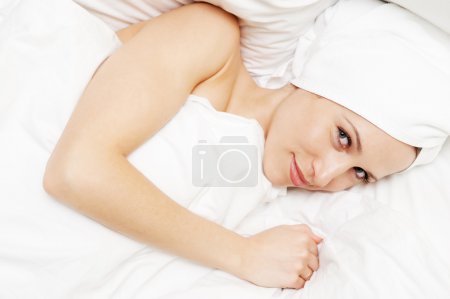 Bright picture of young smiley woman in the bed
