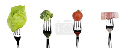 Fresh raw vegetable and meat food on forks over white background