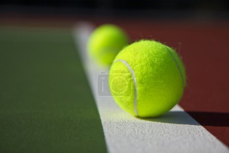 New Tennis Balls shot on a brand new outdoor tennis court