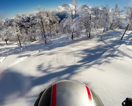 Skiing in fresh snow. POV using action cam on the helmet