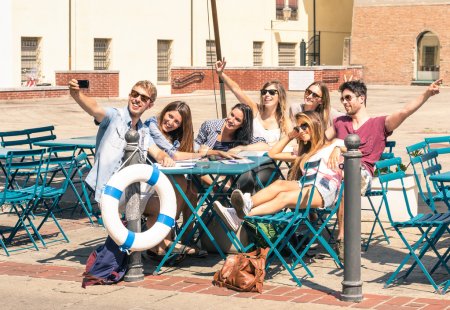 Group of happy best friends taking a selfie - Tourists having fun in the summer around the old town - University students during a break in a sunny day