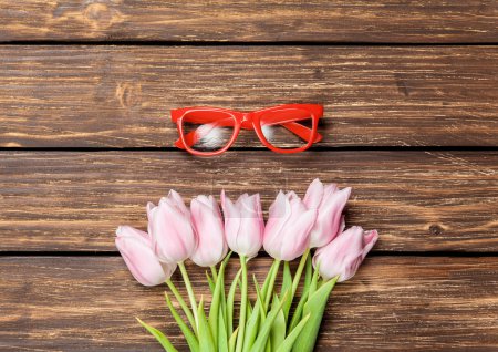 Red glasses and bouquet of tulips 