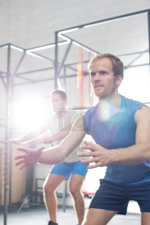 men exercising in crossfit gym