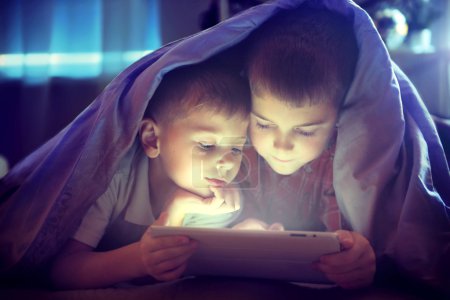 Two kids using tablet pc