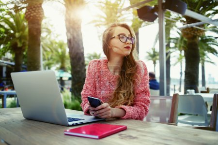 Female freelancer working outdoors