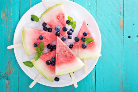 Fresh watermelon popsicles with blueberries