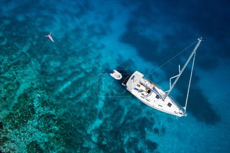 amazing view to yacht, swimming woman and clear water caribbean 
