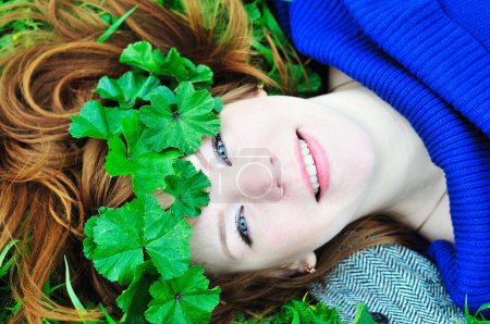 Redheaded girl with crown from leaves