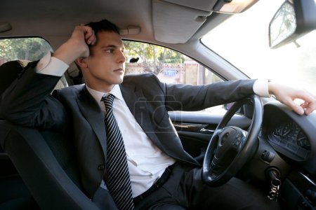 Young suit businessman inside his car