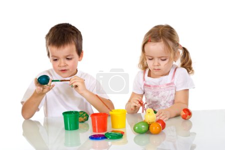 Boy and girl painting the easter eggs