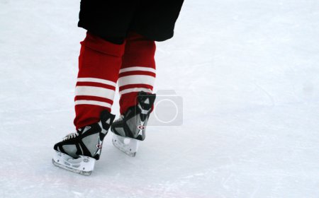 Hockey player skates on ice