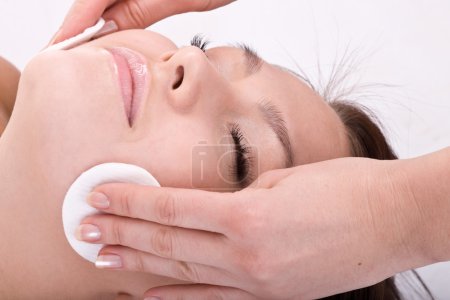 Beautiful woman in spa. Facial massage.