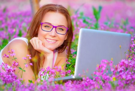 Happy female with laptop outside