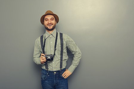hipster man holding retro camera