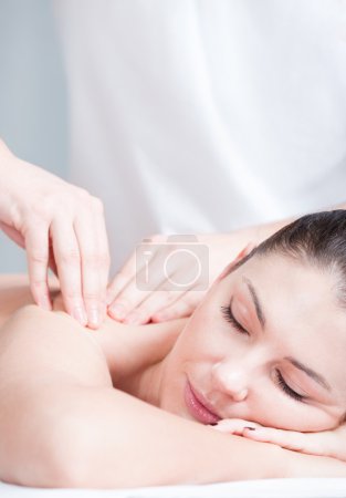 Woman having massage on her shoulder