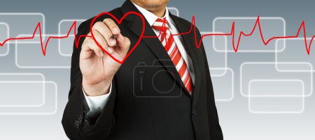 Businessman draw a pulse line with heart