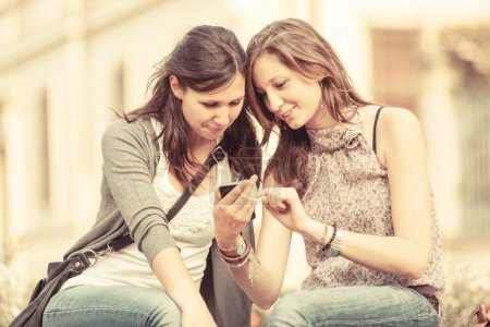Two Beautiful Women Sending Messages with Mobile