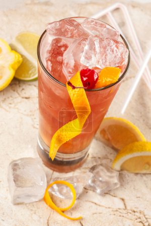 Refreshing red drink with grapefruit, lemon and ice