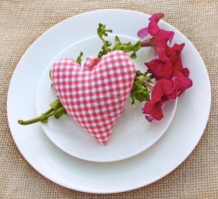 Romantic serving with a bouquet of petunia and heart