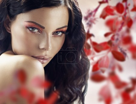 Sensual brunette lady over the petals background