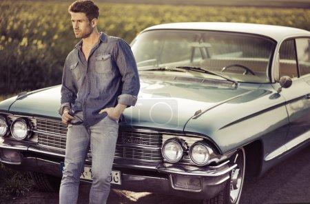 Elegant male model with the retro car