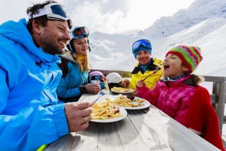 Winter, ski - skiers enjoying lunch in winter mountains