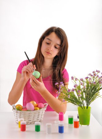 Girl painted Easter eggs isolated on a white background