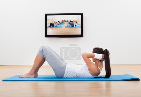 Athletic woman working out at home