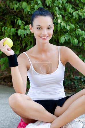 Girl holding a yellow apple