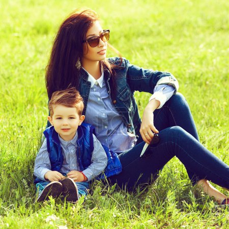 Portrait of fashionable baby boy and his stylish mother in trend