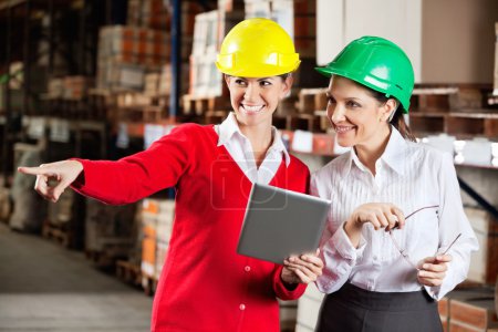 Female Supervisor With Colleague At Warehouse