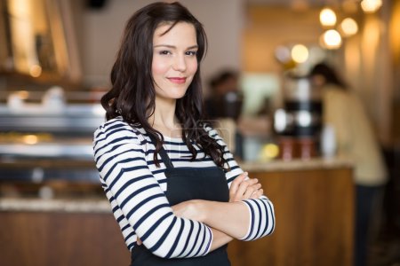 Pretty Waitress Standing Arms Crossed In Cafeteria