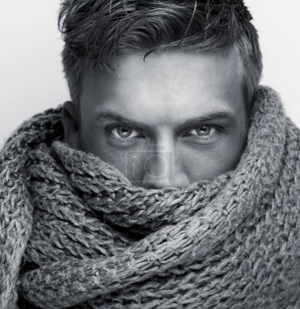 Portrait of a fashion model face covered by scarf