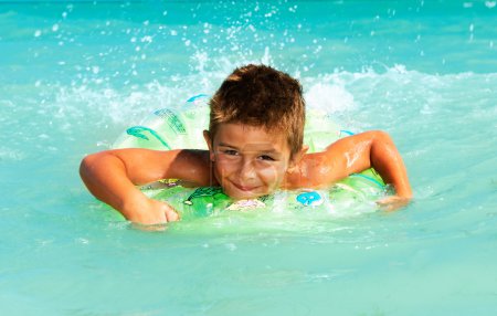 Happy Child Playing in Swimming in Sea. Summer Vacations Concept