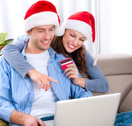 Christmas Online Shopping. Couple Using Credit Card to E-Shop
