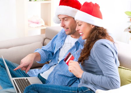 Couple with credit card buying online. Christmas Shopping