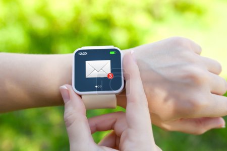 Isolated female hands with white smartwatch with email on the sc