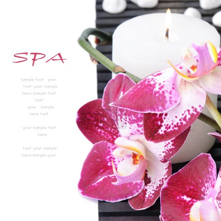 Spa setting with purple orchid and candle