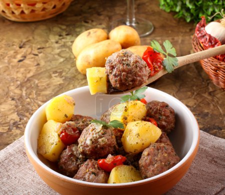 Meatballs with tomato sauce with potatoes in broth