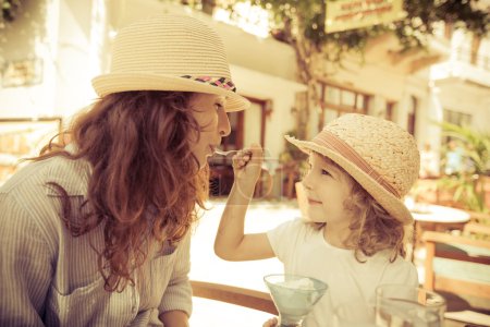 Hipster woman and girl in summer cafe