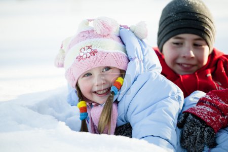 Portrait of children playing in the snow in the winter