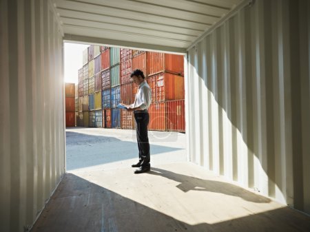 Business man with shipping containers