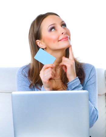 Happy Woman shopping on-line with credit card and computer.Inter