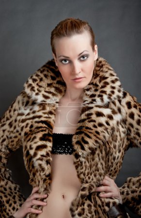Portrait of a beautiful young woman in a fur.