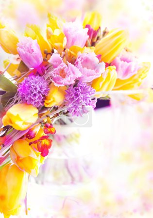Vernal flowers bouquet over blurred background