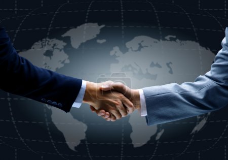 Handshake with map of the world in background