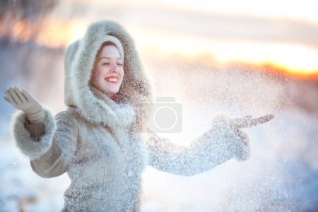 Woman throwing up snow